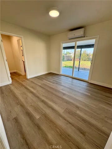 an empty room with wooden floor and doors