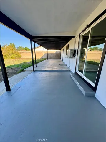 a view of an empty room with a floor to ceiling window