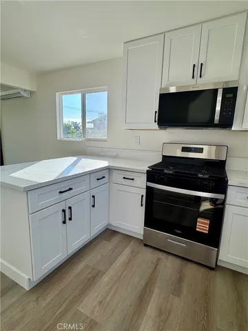 a kitchen with cabinets appliances and a sink