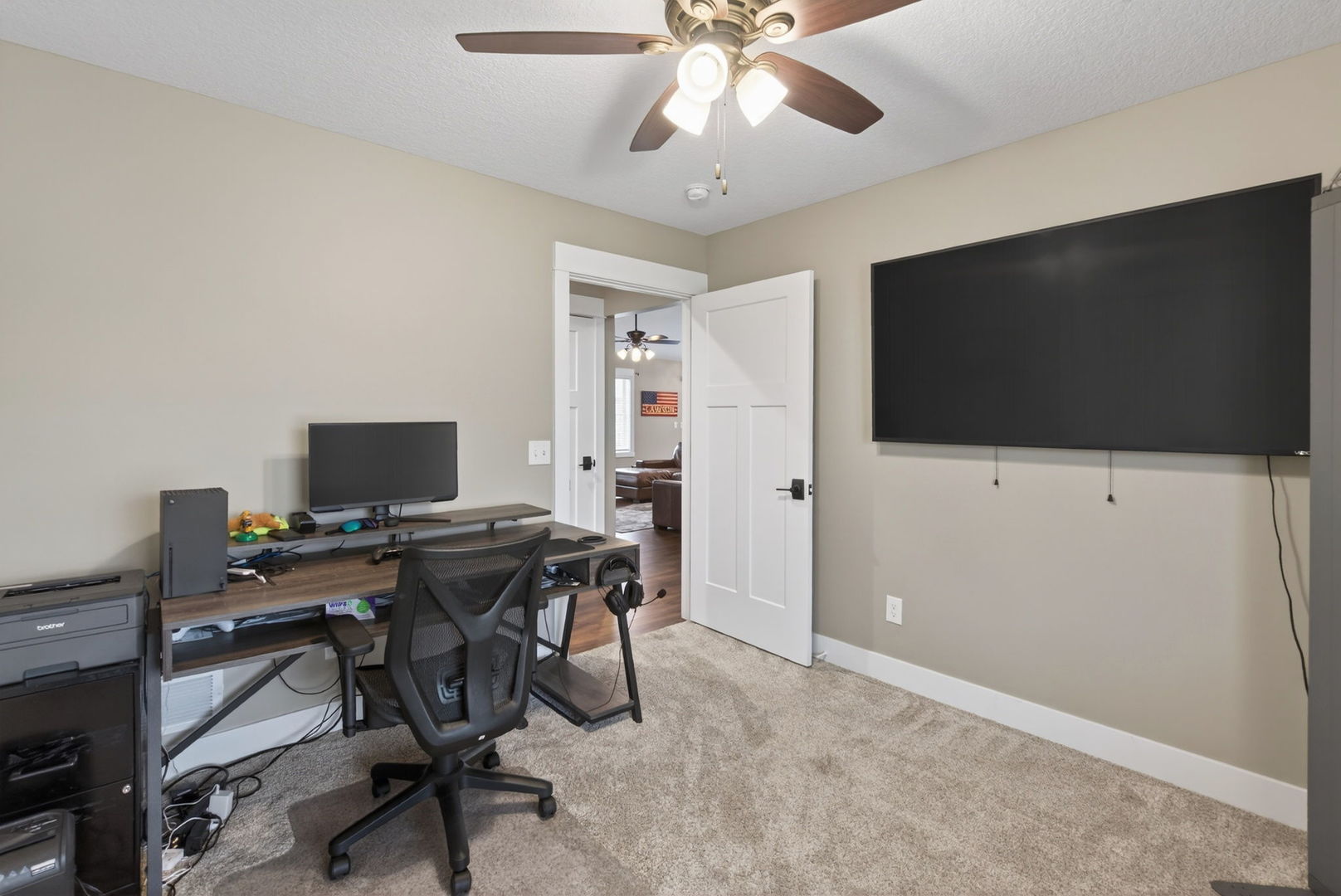 1439 Rhinelander Drive Davenport, IA 52804 - Photo 17 of 43 a view of a workspace with furniture and a flat screen tv