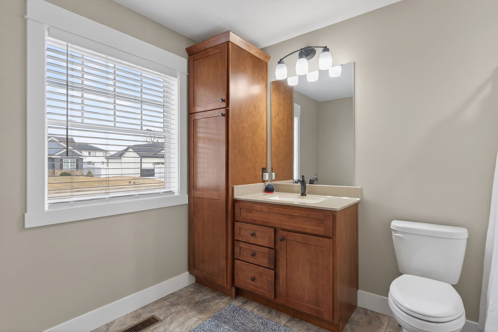 1439 Rhinelander Drive Davenport, IA 52804 - Photo 18 of 43 a bathroom with a toilet sink and mirror
