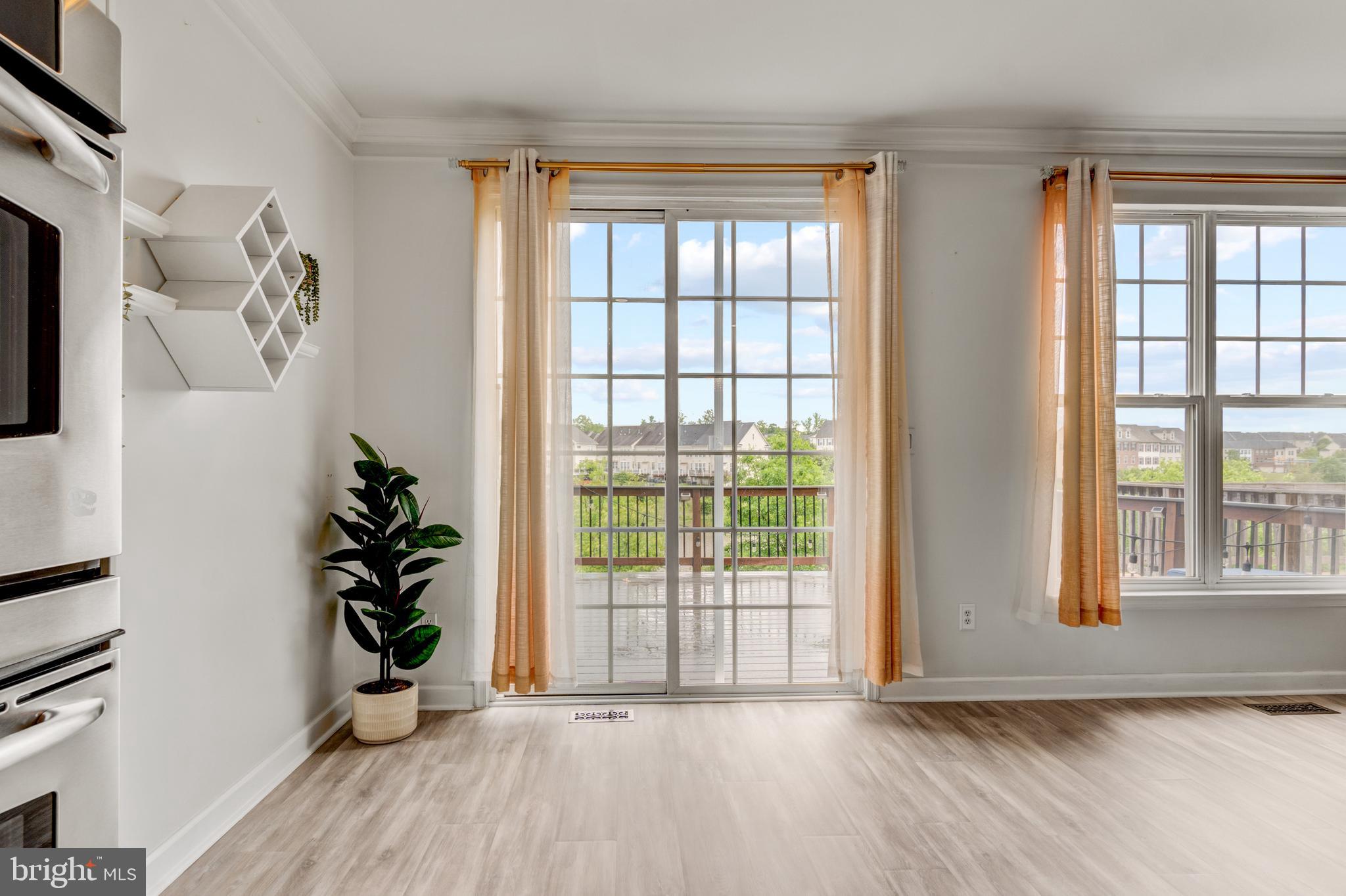 9183 Cascade Falls Drive Bristow, VA 20136 - Photo 18 of 45 a view of an empty room with a window and wooden floor