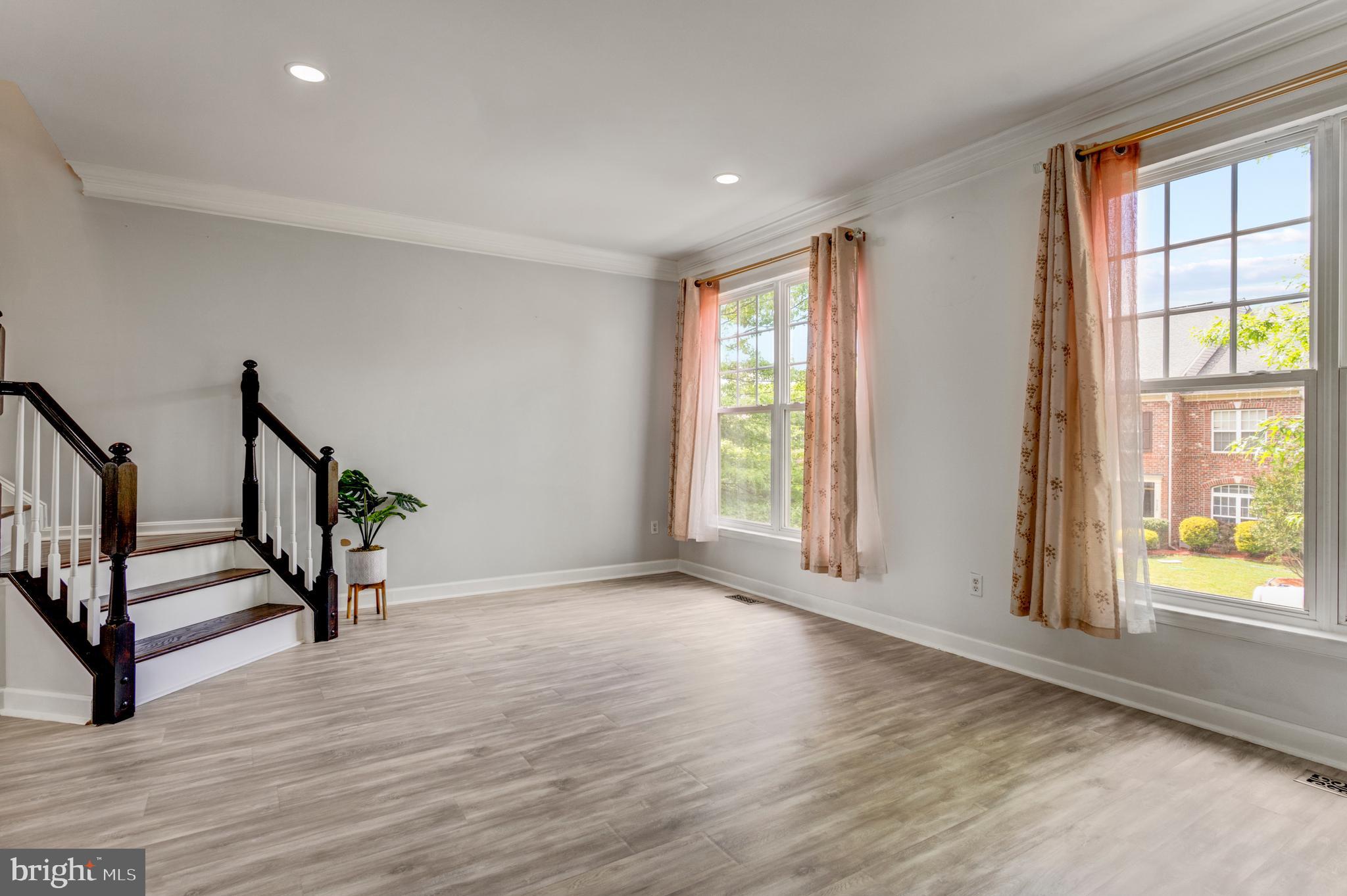 9183 Cascade Falls Drive Bristow, VA 20136 - Photo 20 of 45 a view of an empty room with wooden floor and a window