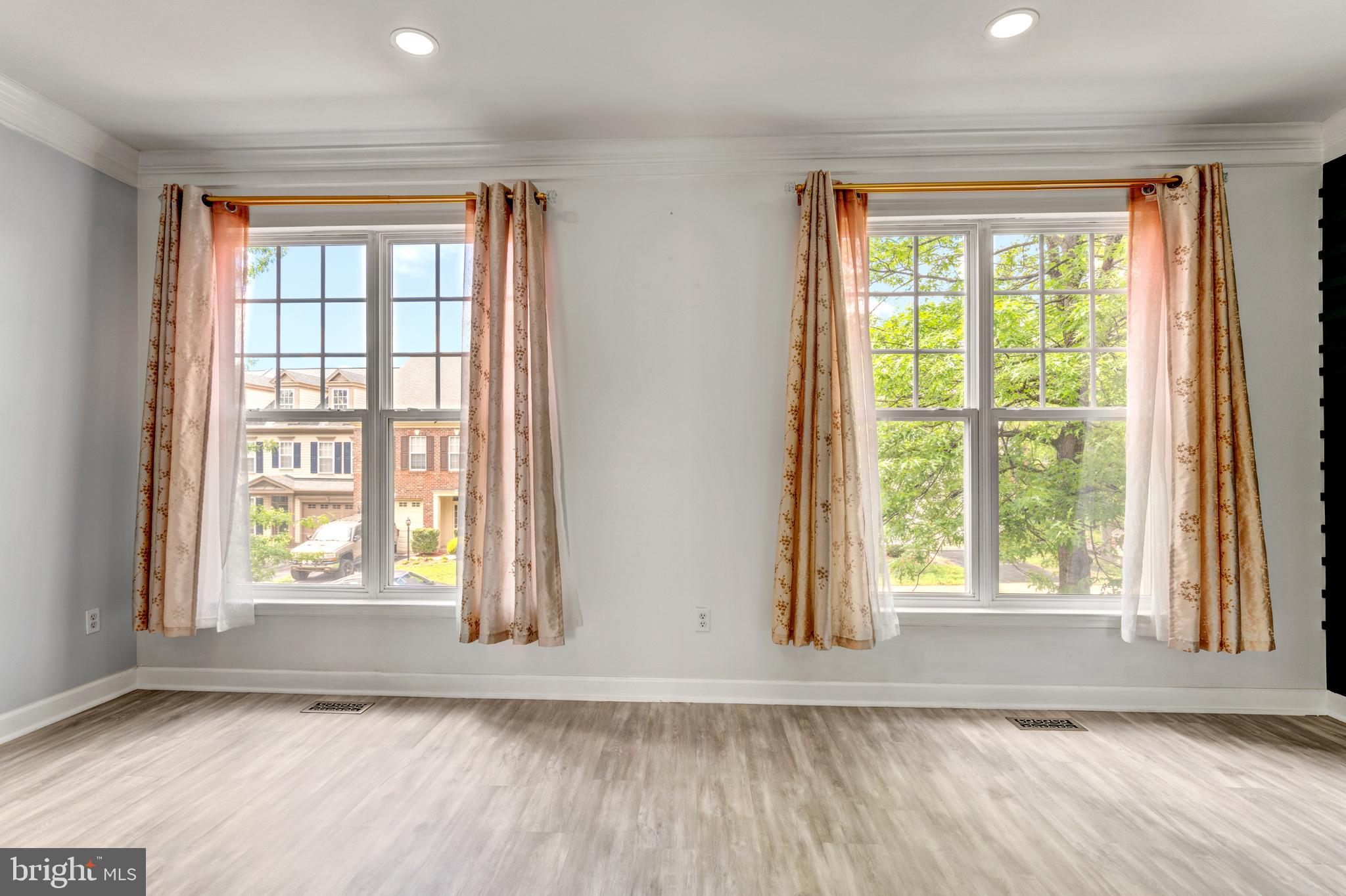 9183 Cascade Falls Drive Bristow, VA 20136 - Photo 24 of 45 an empty room with wooden floor and windows