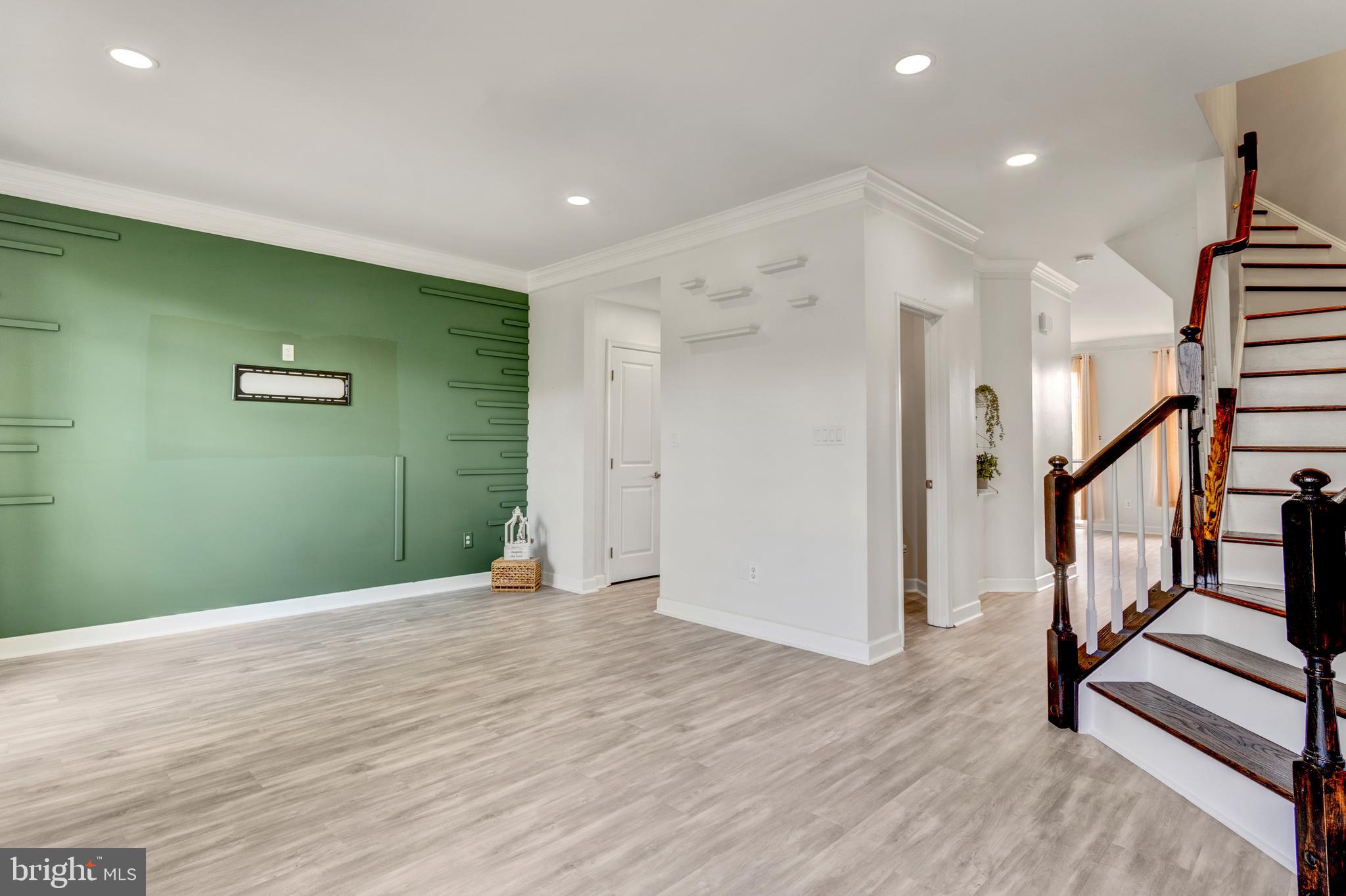 9183 Cascade Falls Drive Bristow, VA 20136 - Photo 25 of 45 a view of an empty room with wooden floor and stairs