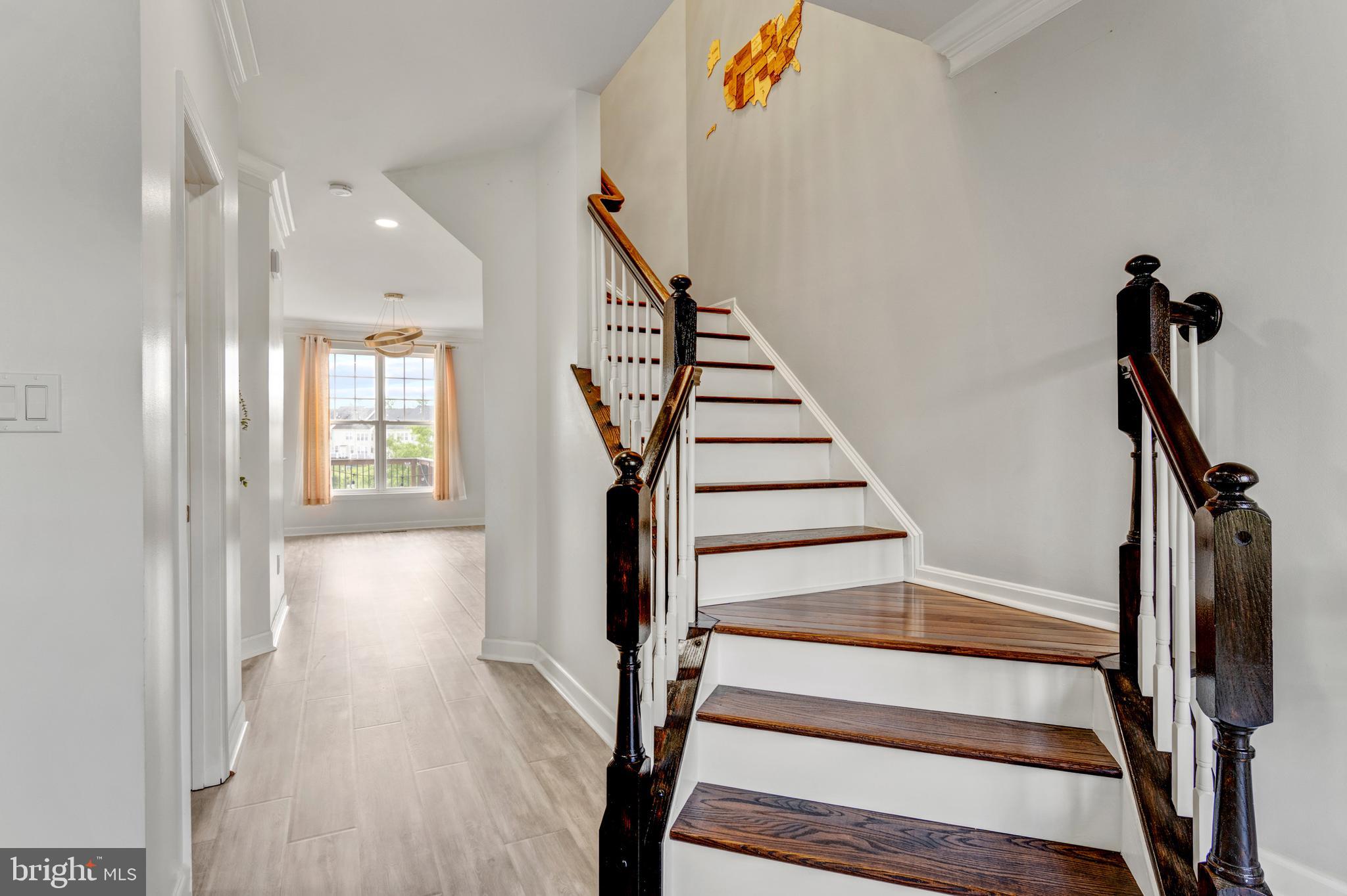 9183 Cascade Falls Drive Bristow, VA 20136 - Photo 27 of 45 a view of entryway with wooden floor and stairs