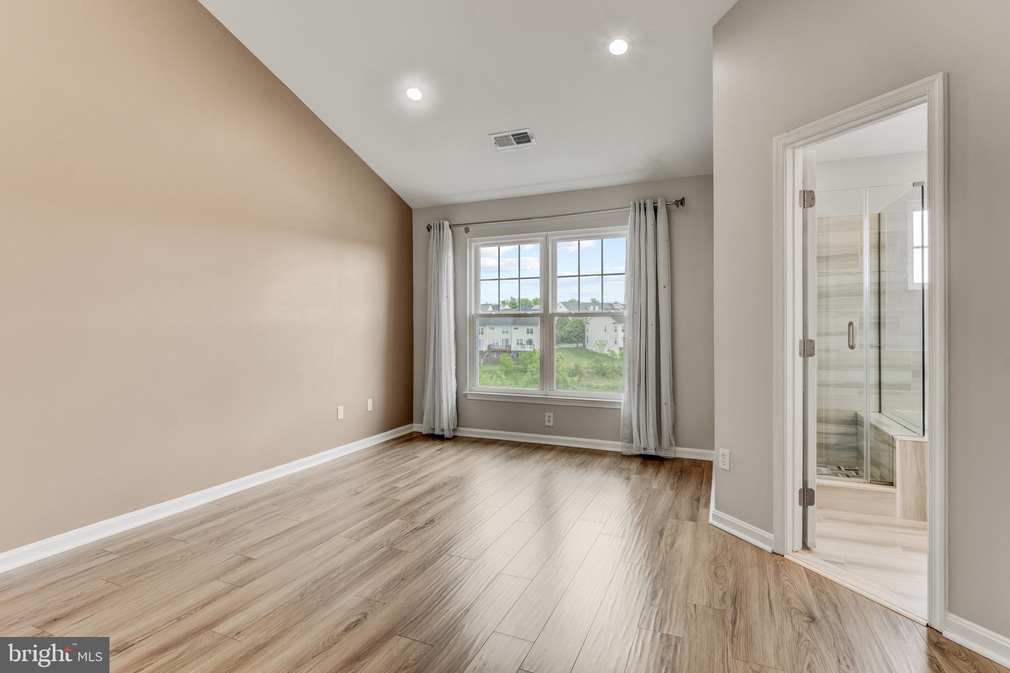 9183 Cascade Falls Drive Bristow, VA 20136 - Photo 29 of 45 an empty room with wooden floor and windows