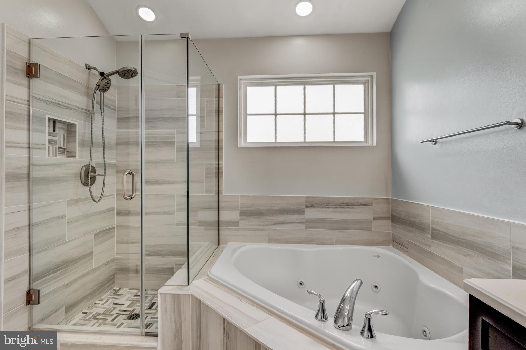 9183 Cascade Falls Drive Bristow, VA 20136 - Photo 35 of 45 a bathroom with a bathtub and a shower
