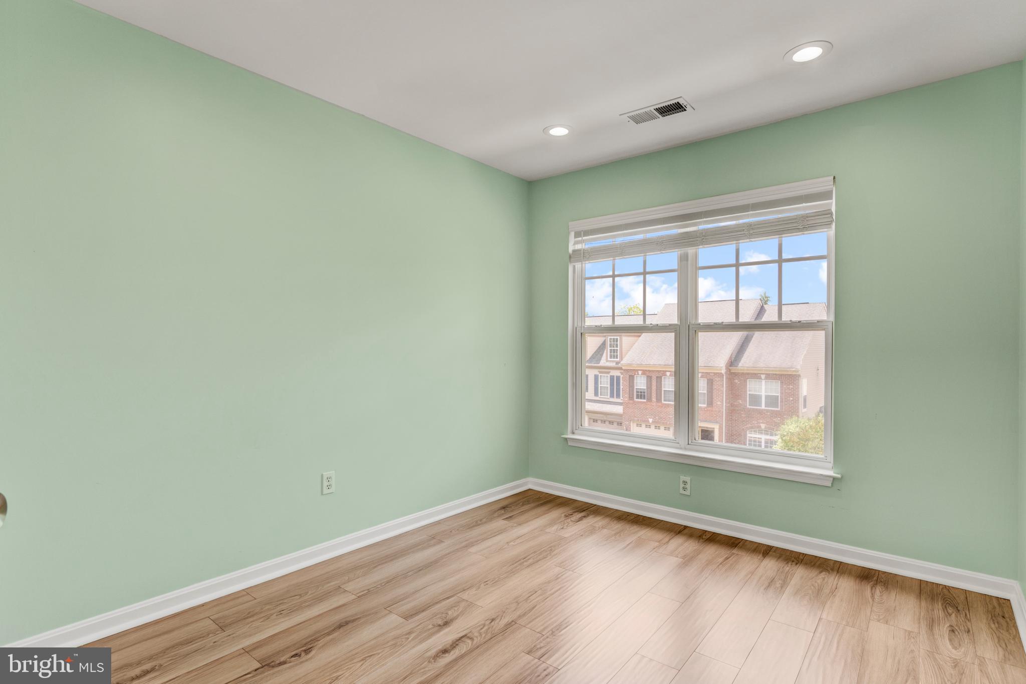 9183 Cascade Falls Drive Bristow, VA 20136 - Photo 41 of 45 an empty room with wooden floor and windows