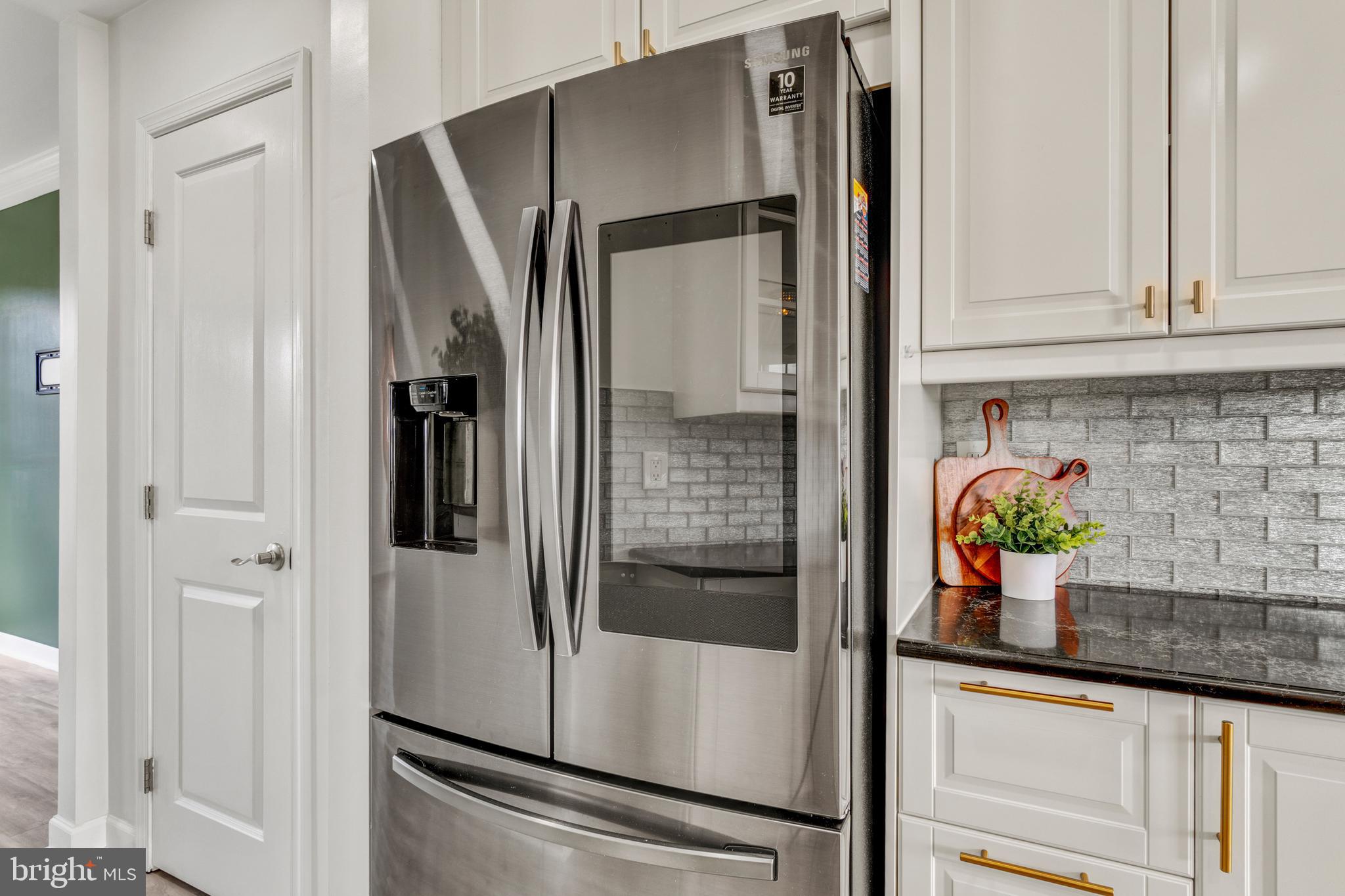 9183 Cascade Falls Drive Bristow, VA 20136 - Photo 7 of 45 a view of a refrigerator and microwave