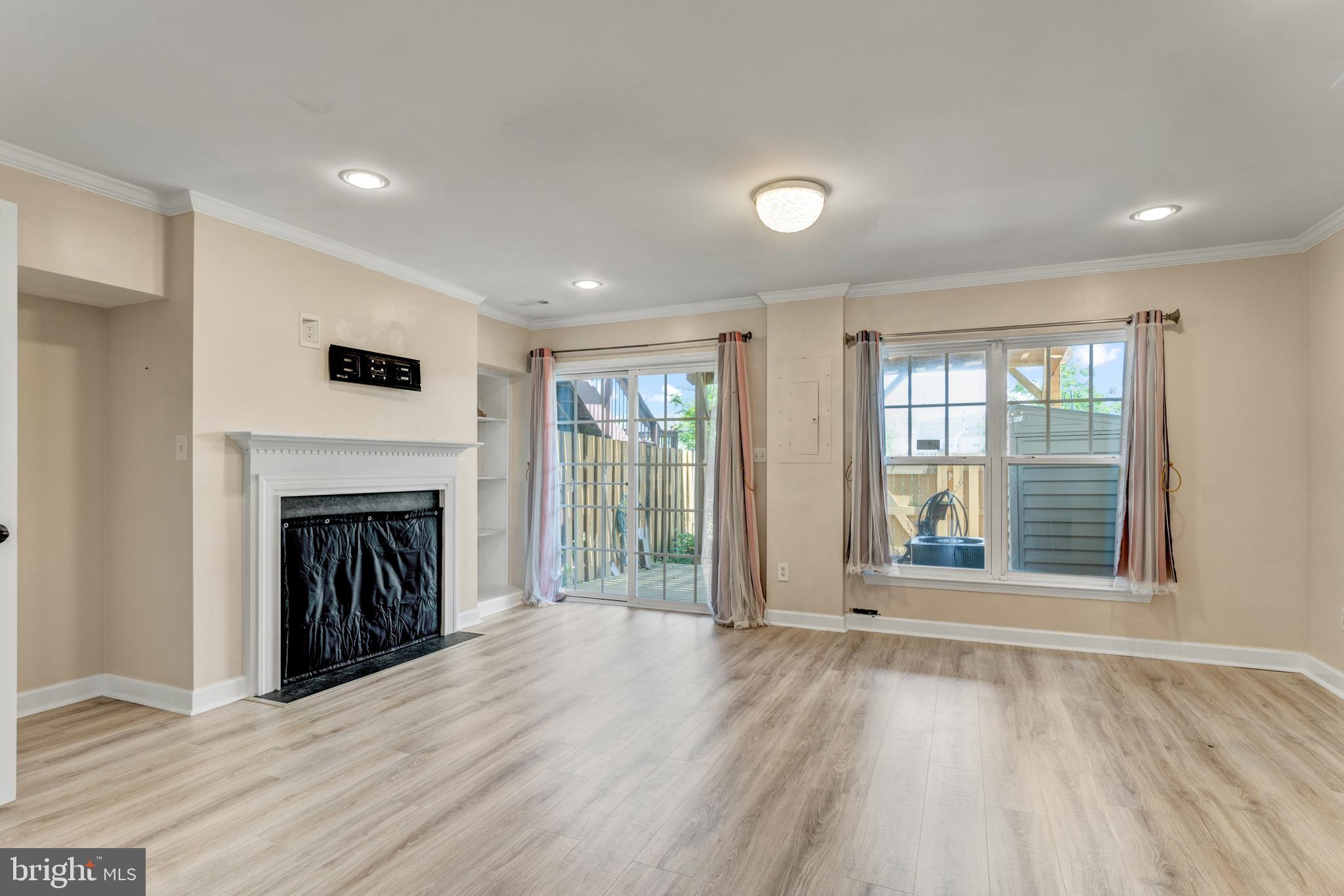 9183 Cascade Falls Drive Bristow, VA 20136 - Photo 10 of 45 a view of an empty room with wooden floor and a window