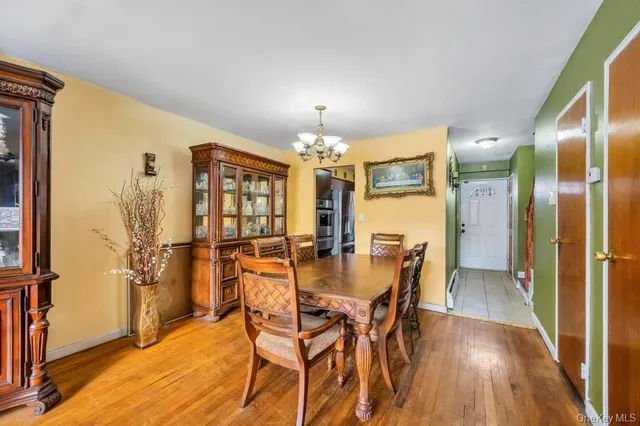 a view of a dining room with furniture and chandelier