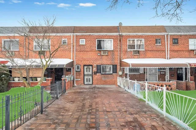 an outdoor view of a house with a backyard