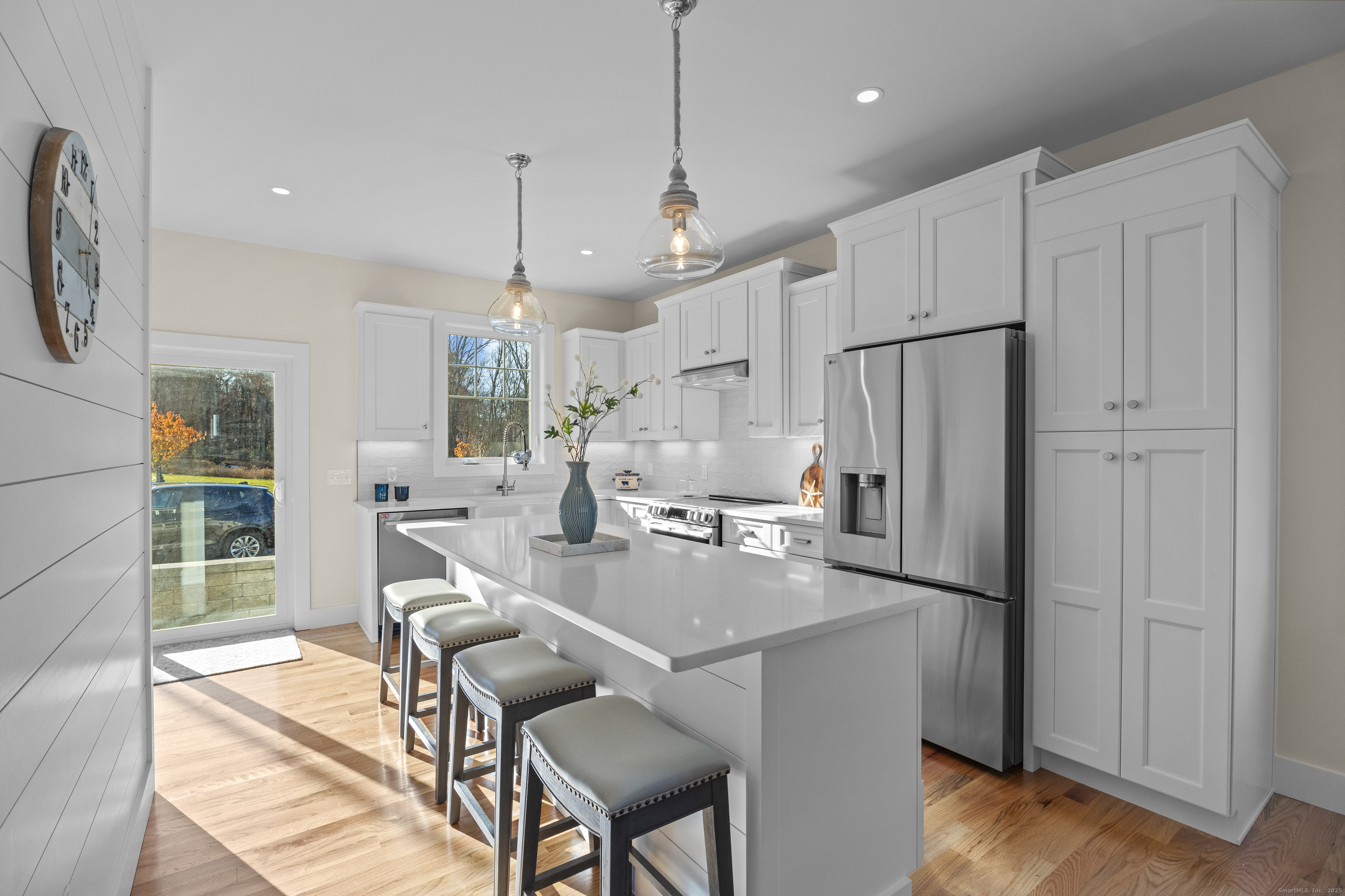 7 Ivy Hill Road, Unit 7 Waterford, CT 06385 - Photo 6 of 35 a kitchen with refrigerator and chairs