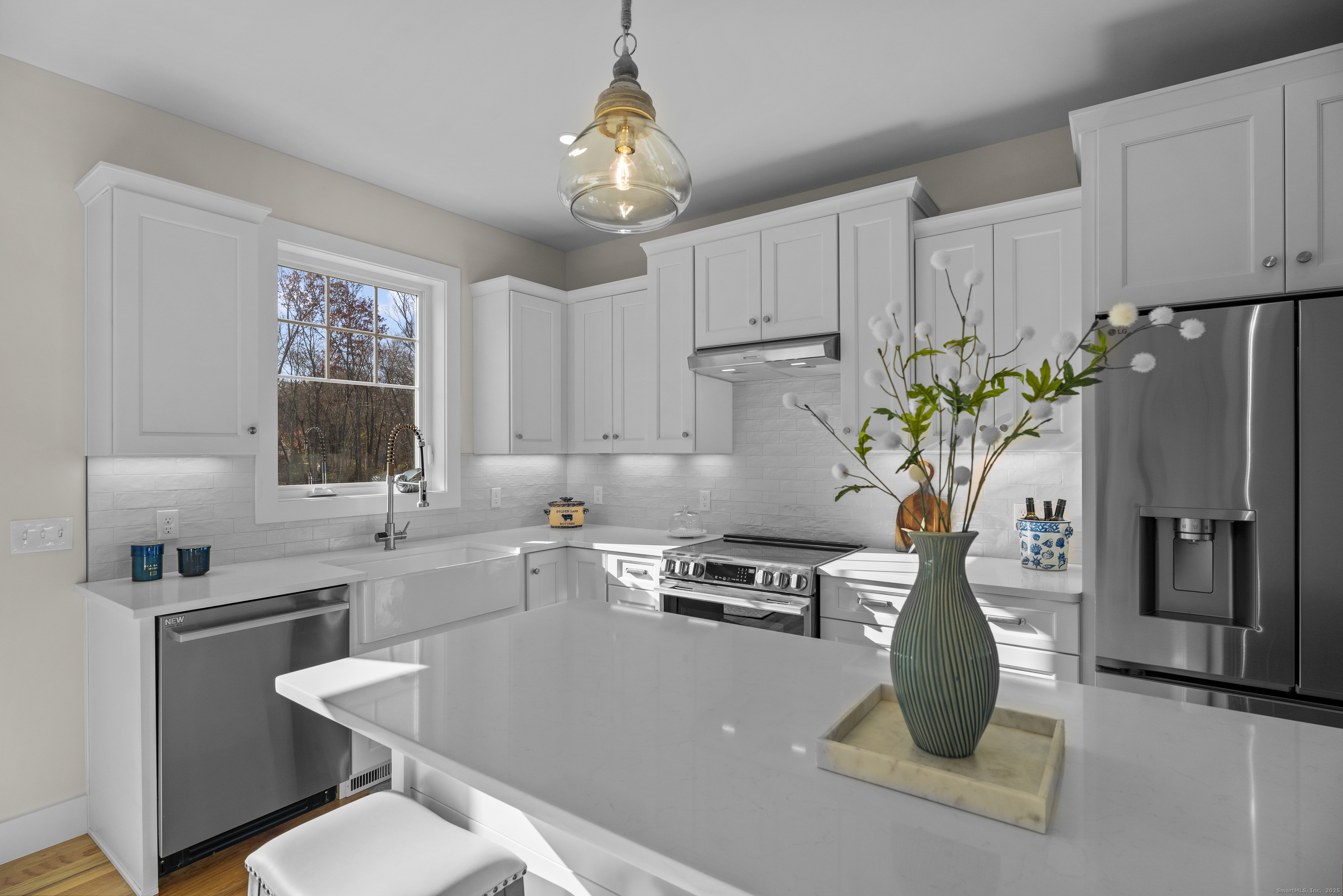 7 Ivy Hill Road, Unit 7 Waterford, CT 06385 - Photo 9 of 35 a kitchen with stainless steel appliances a sink a table and chairs