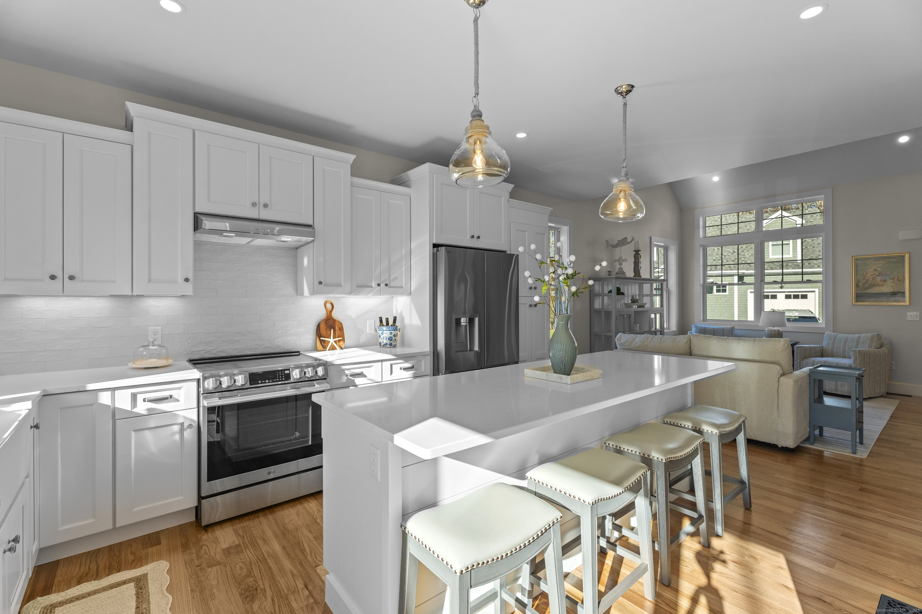 7 Ivy Hill Road, Unit 7 Waterford, CT 06385 - Photo 10 of 35 a kitchen with stainless steel appliances granite countertop a stove a sink a refrigerator a stove a dining table and chairs with wooden floor