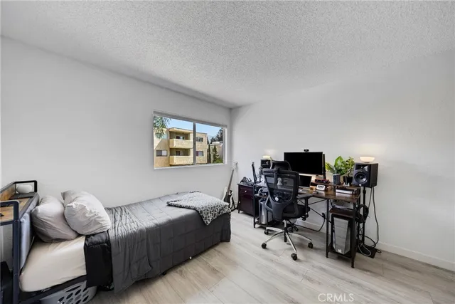 a bedroom with a bed and a chair