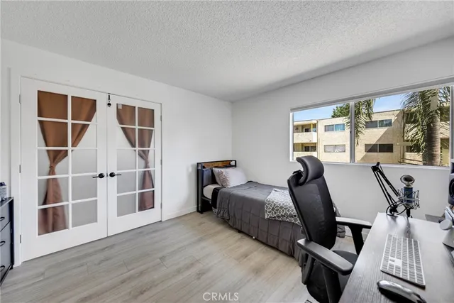 a bedroom with furniture and a window