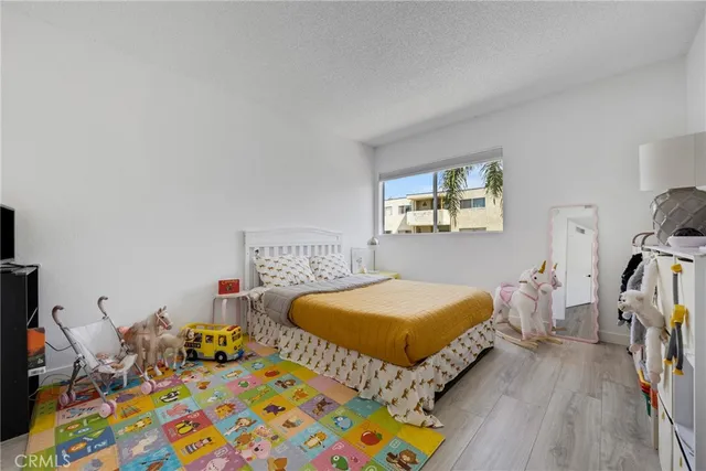 a bedroom with two beds and a dresser