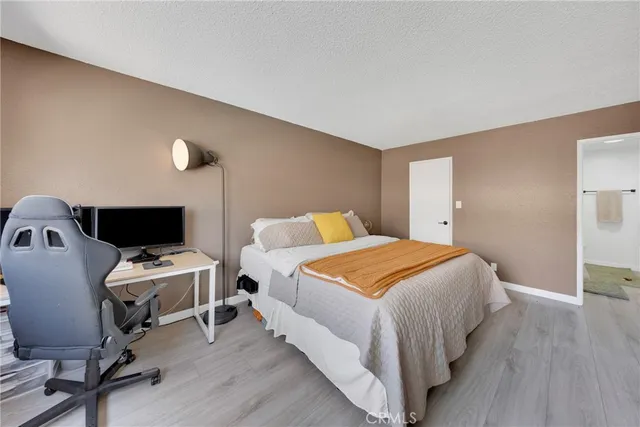 a bedroom with a bed and a chair