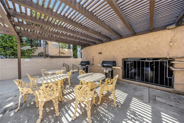 a view of a patio with table and chairs with wooden floor and fence