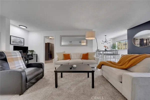 a living room with furniture and a lamp