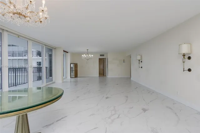 a kitchen with granite countertop white cabinets and appliances