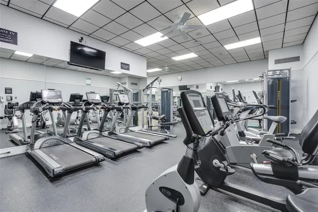 a living room with furniture a chandelier and a rug