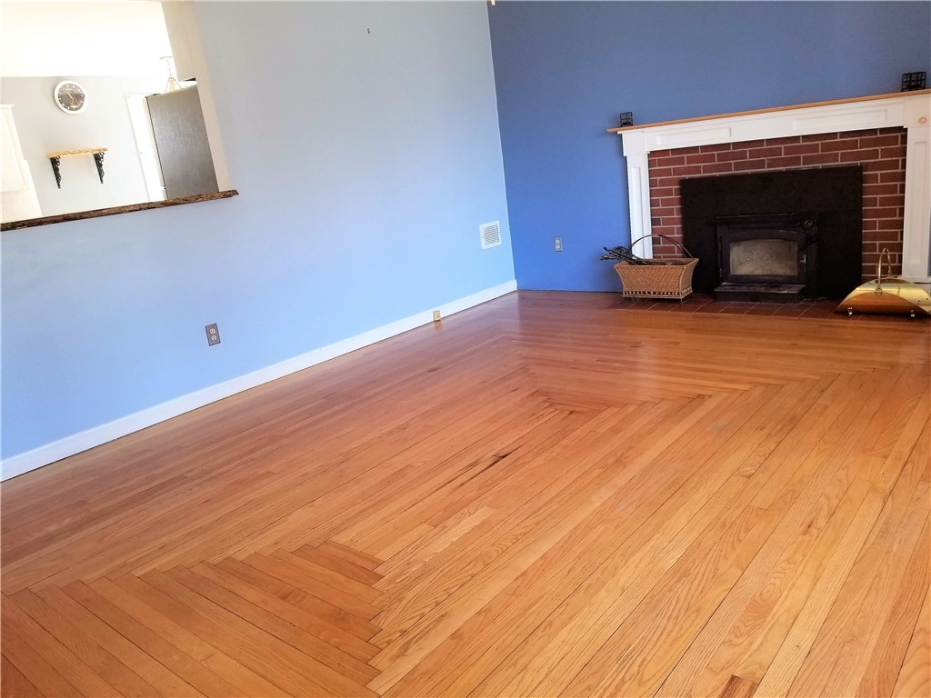 63 Long Meadow Road Portsmouth, RI 02871 - Photo 11 of 27 living room with wood stove insert in fireplace