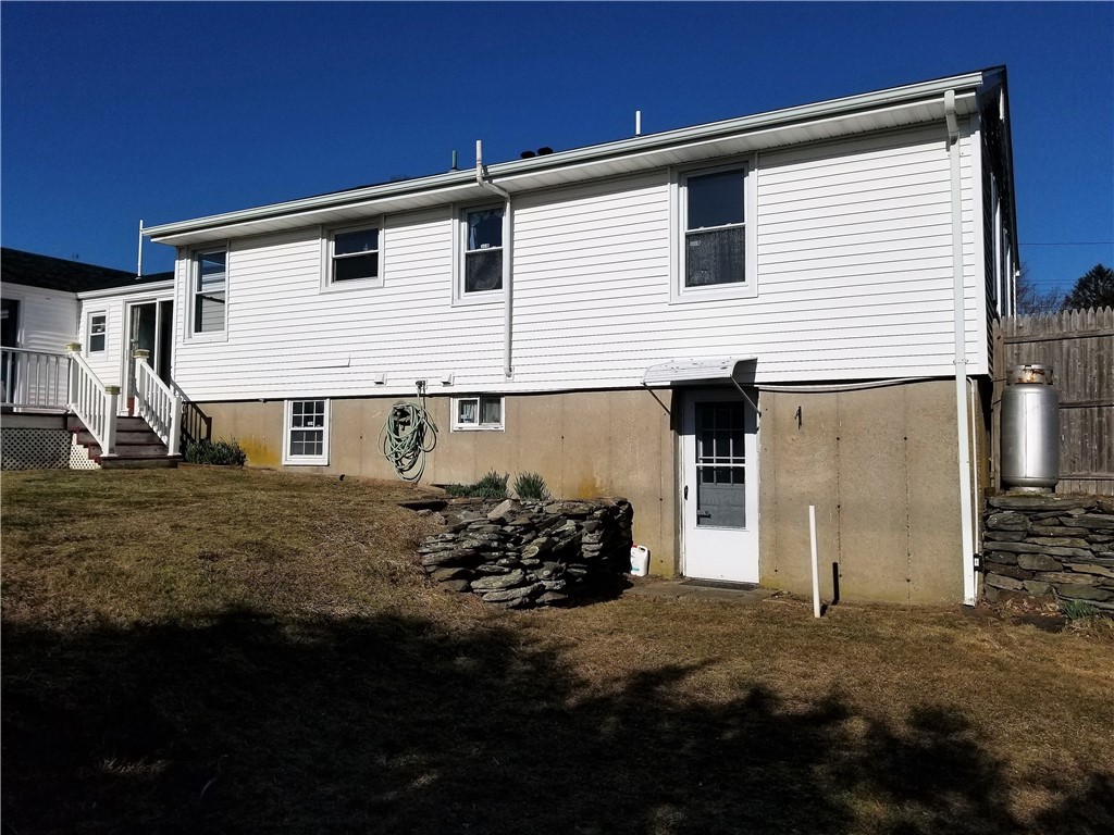 63 Long Meadow Road Portsmouth, RI 02871 - Photo 27 of 27 back of house, door is to finished in law apartment in lower level