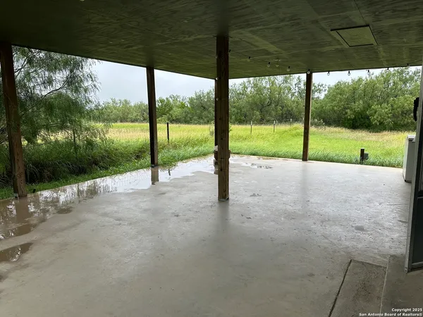 a view of a house with porch and a yard