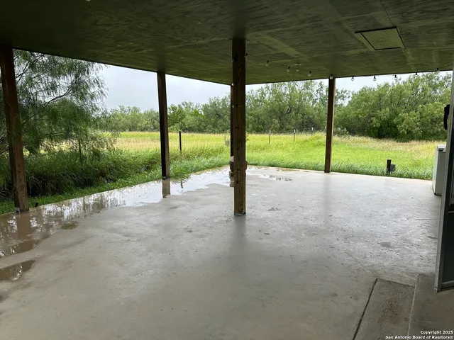 a view of a house with porch and a yard