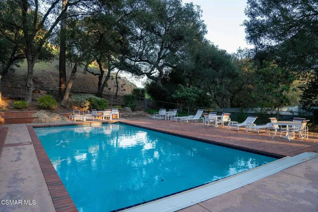 a view of a swimming pool with a table and chairs