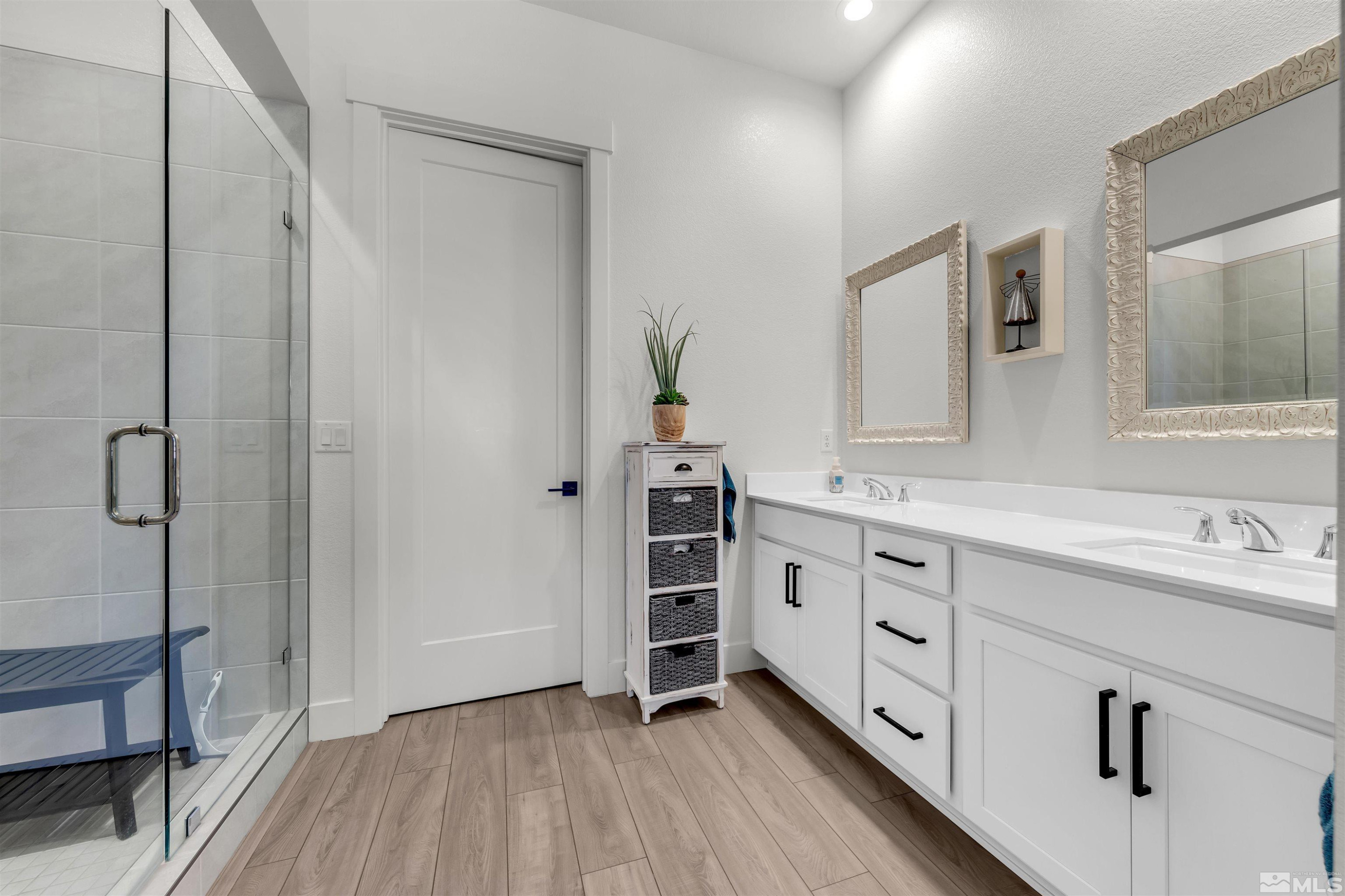 7341 Rustic Sky Drive Sparks, NV 89436 - Photo 23 of 40 a bathroom with a double vanity sink a mirror and shower