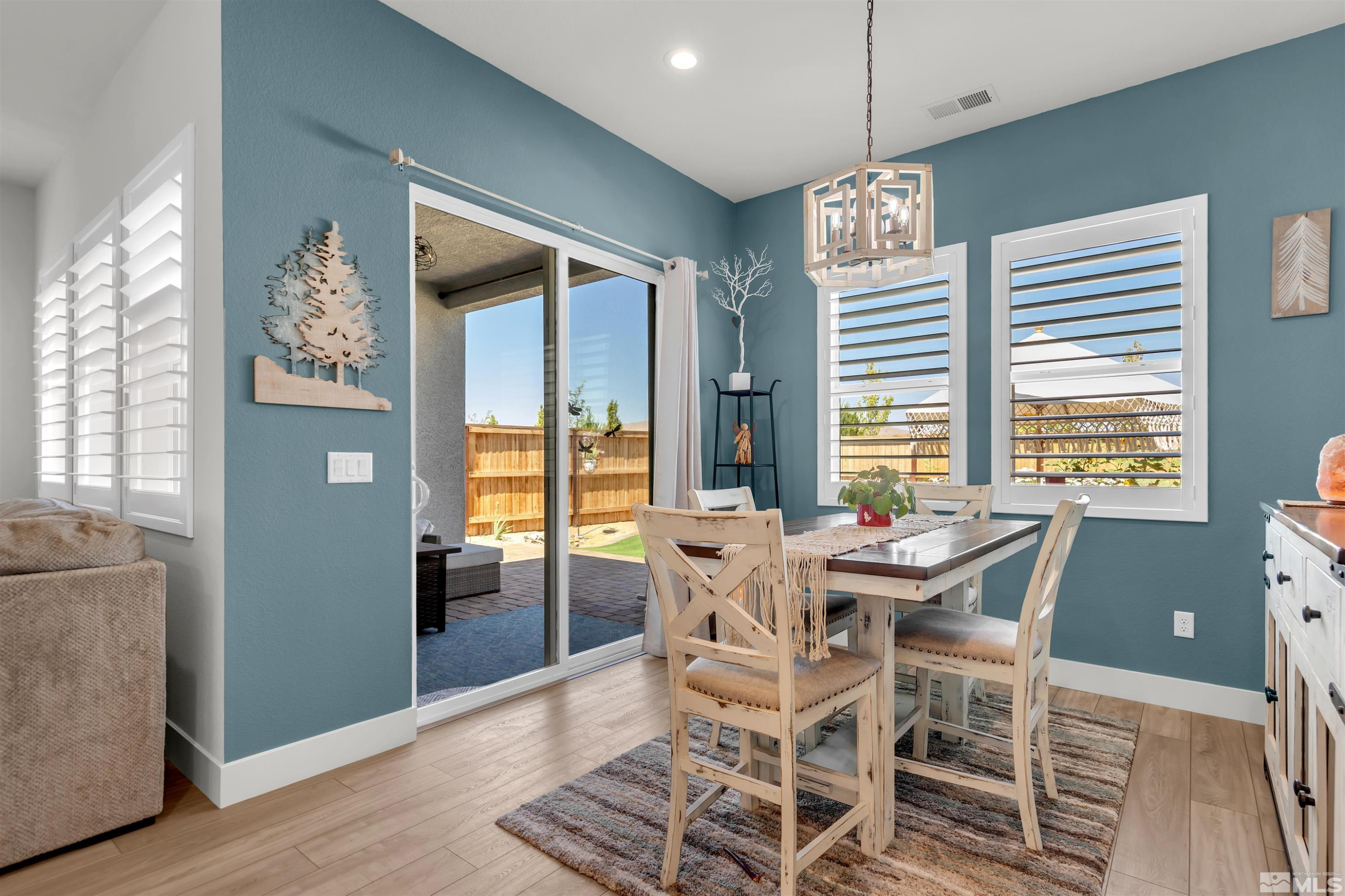 7341 Rustic Sky Drive Sparks, NV 89436 - Photo 7 of 40 a view of a dining room with furniture large window and wooden floor