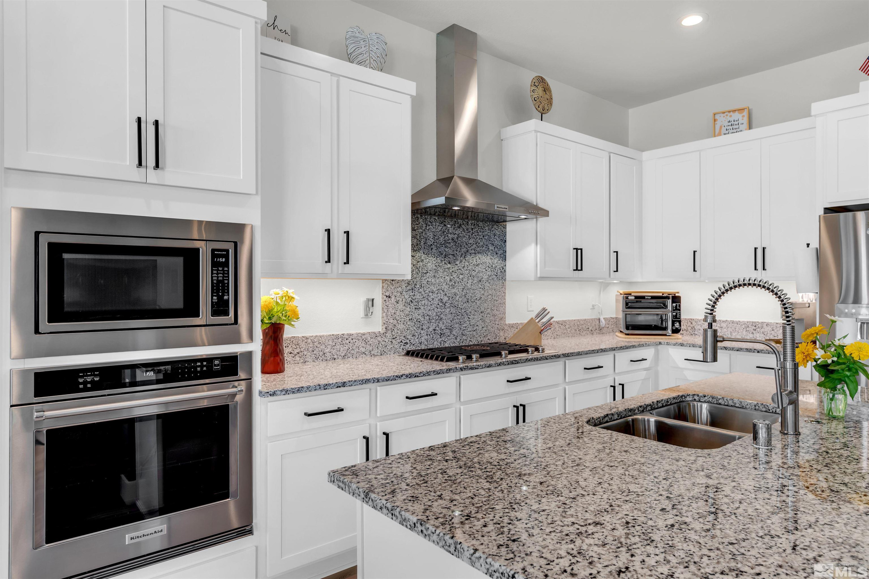 7341 Rustic Sky Drive Sparks, NV 89436 - Photo 10 of 40 a kitchen with granite countertop a stove sink and cabinets