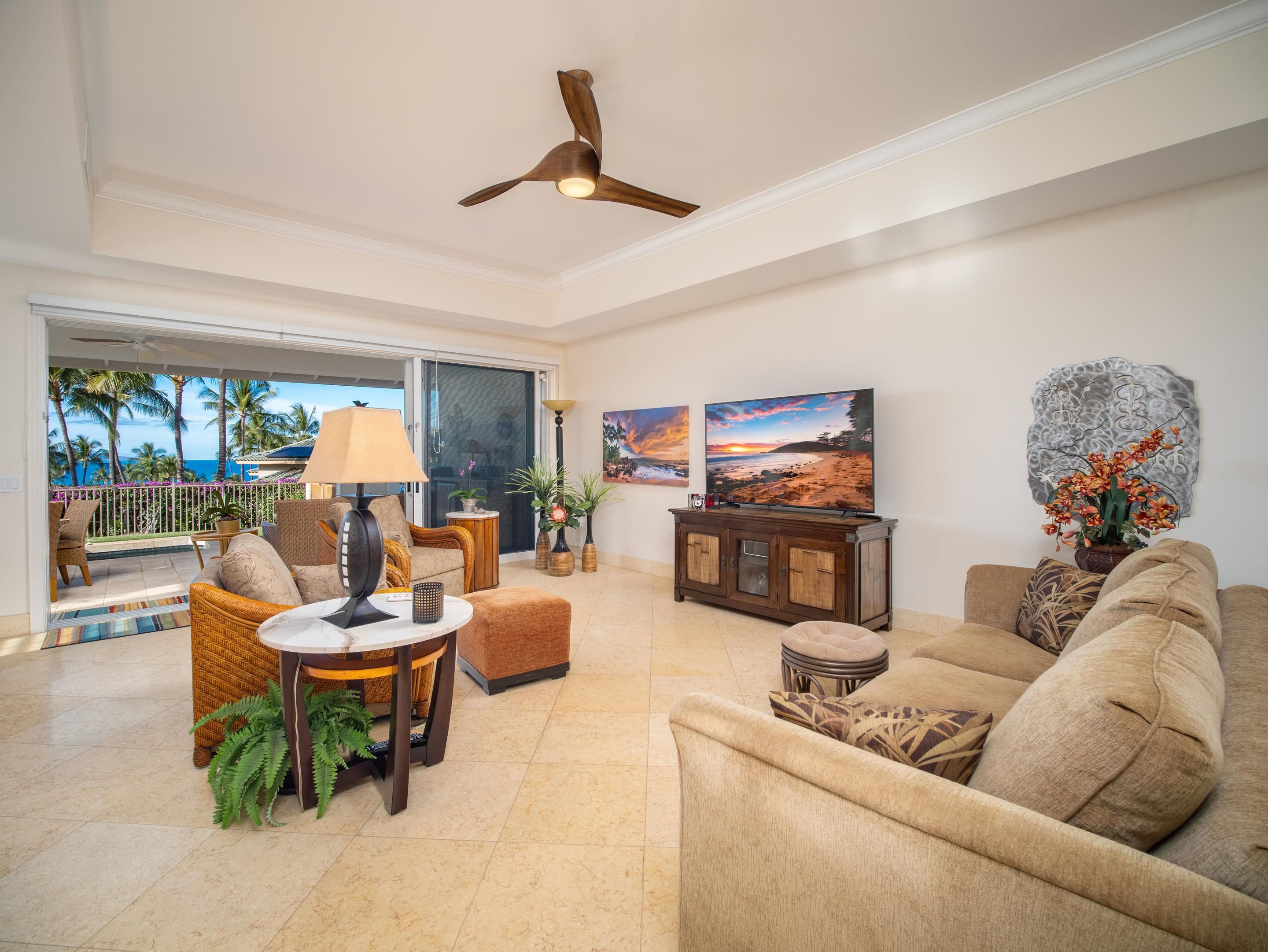 72 Kainui Loop, Unit 70A Kihei, HI 96753 - Photo 2 of 50 a living room with furniture and a large window