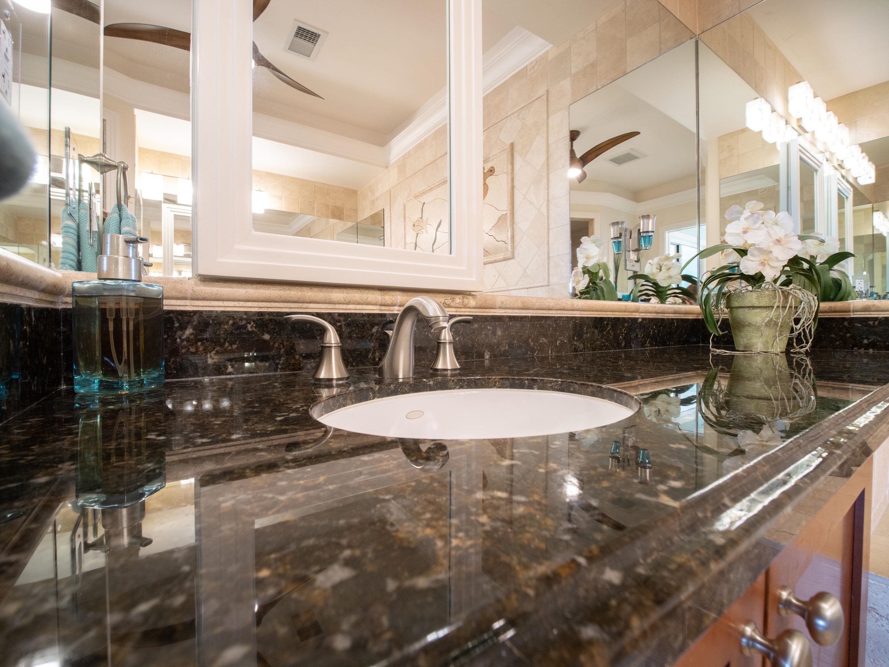 72 Kainui Loop, Unit 70A Kihei, HI 96753 - Photo 29 of 50 a bathroom with a granite countertop sink and a mirror