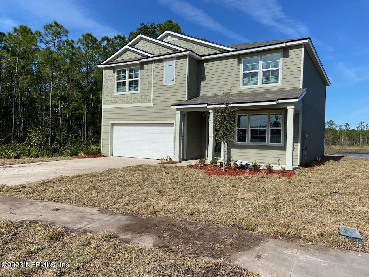 276 Falcon Ridge Road St. Augustine, FL 32084 - Photo 1 of 32 a front view of a house with a yard and garage