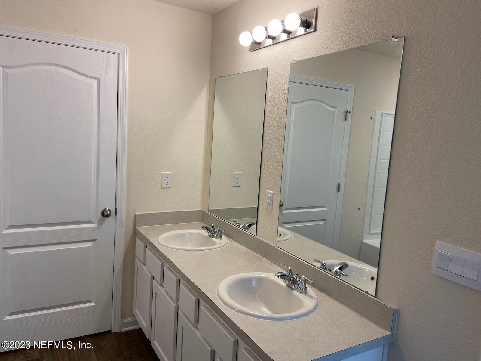 276 Falcon Ridge Road St. Augustine, FL 32084 - Photo 10 of 32 a bathroom with a sink and a mirror