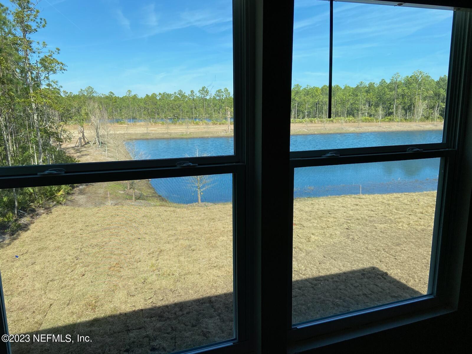 276 Falcon Ridge Road St. Augustine, FL 32084 - Photo 16 of 32 a view of a lake from a window
