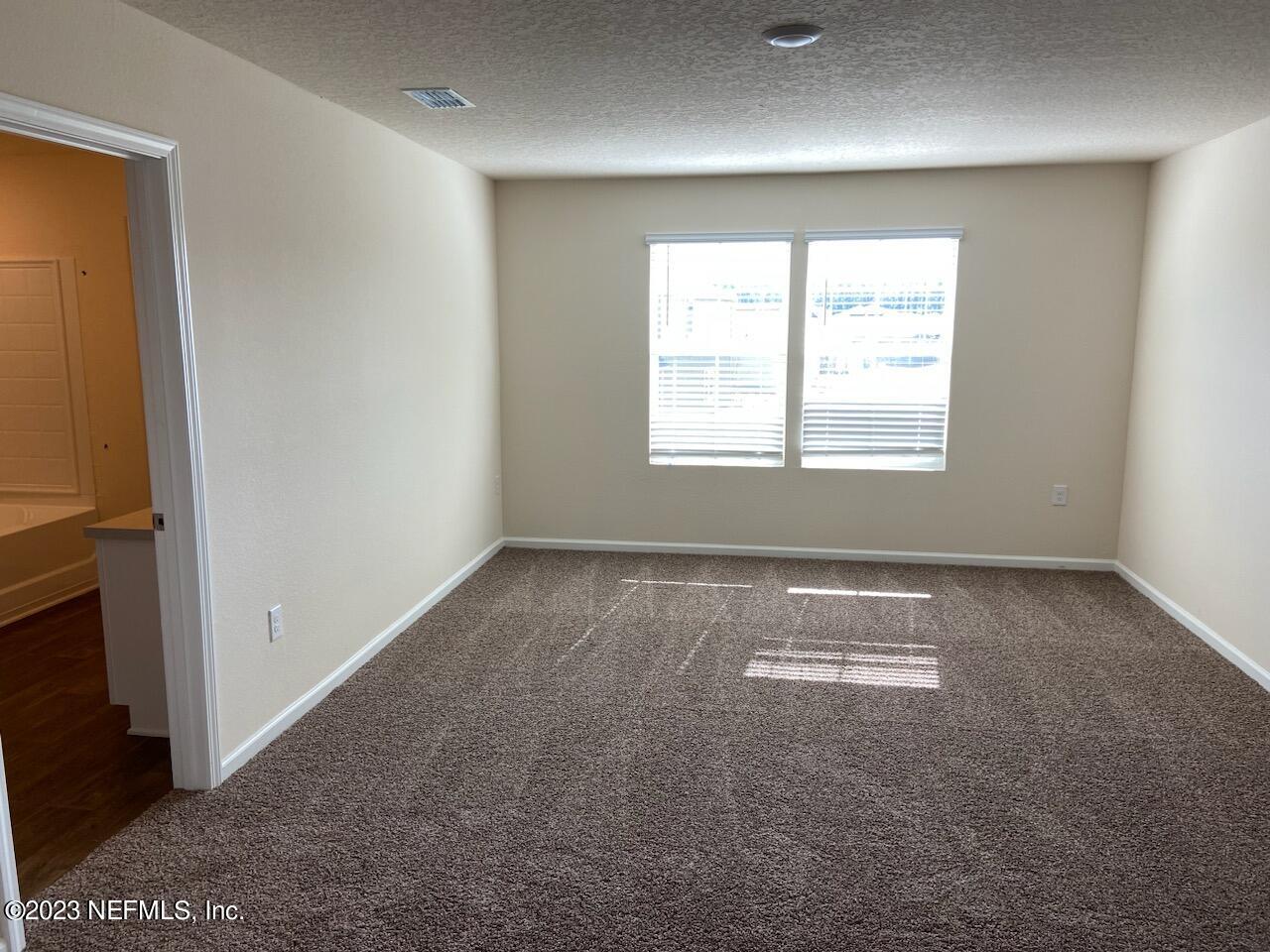 276 Falcon Ridge Road St. Augustine, FL 32084 - Photo 7 of 32 a view of an empty room with a window
