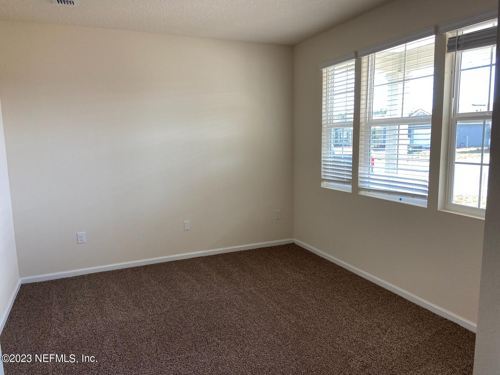 276 Falcon Ridge Road St. Augustine, FL 32084 - Photo 8 of 32 an empty room with a window