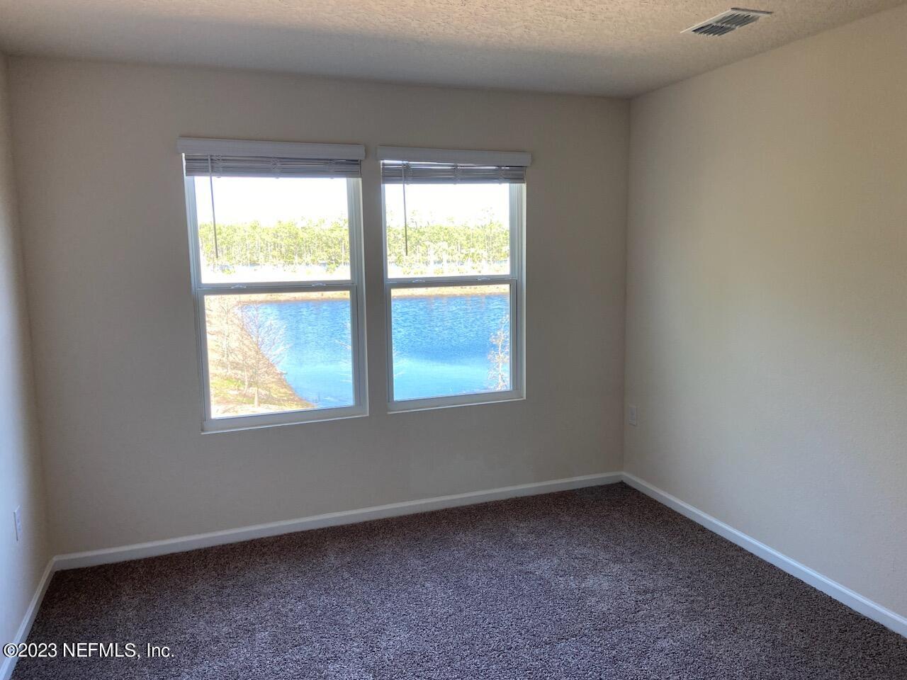 276 Falcon Ridge Road St. Augustine, FL 32084 - Photo 9 of 32 an empty room with a window