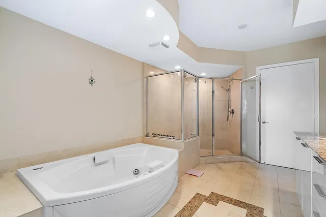 a view of an empty room with furniture and large window