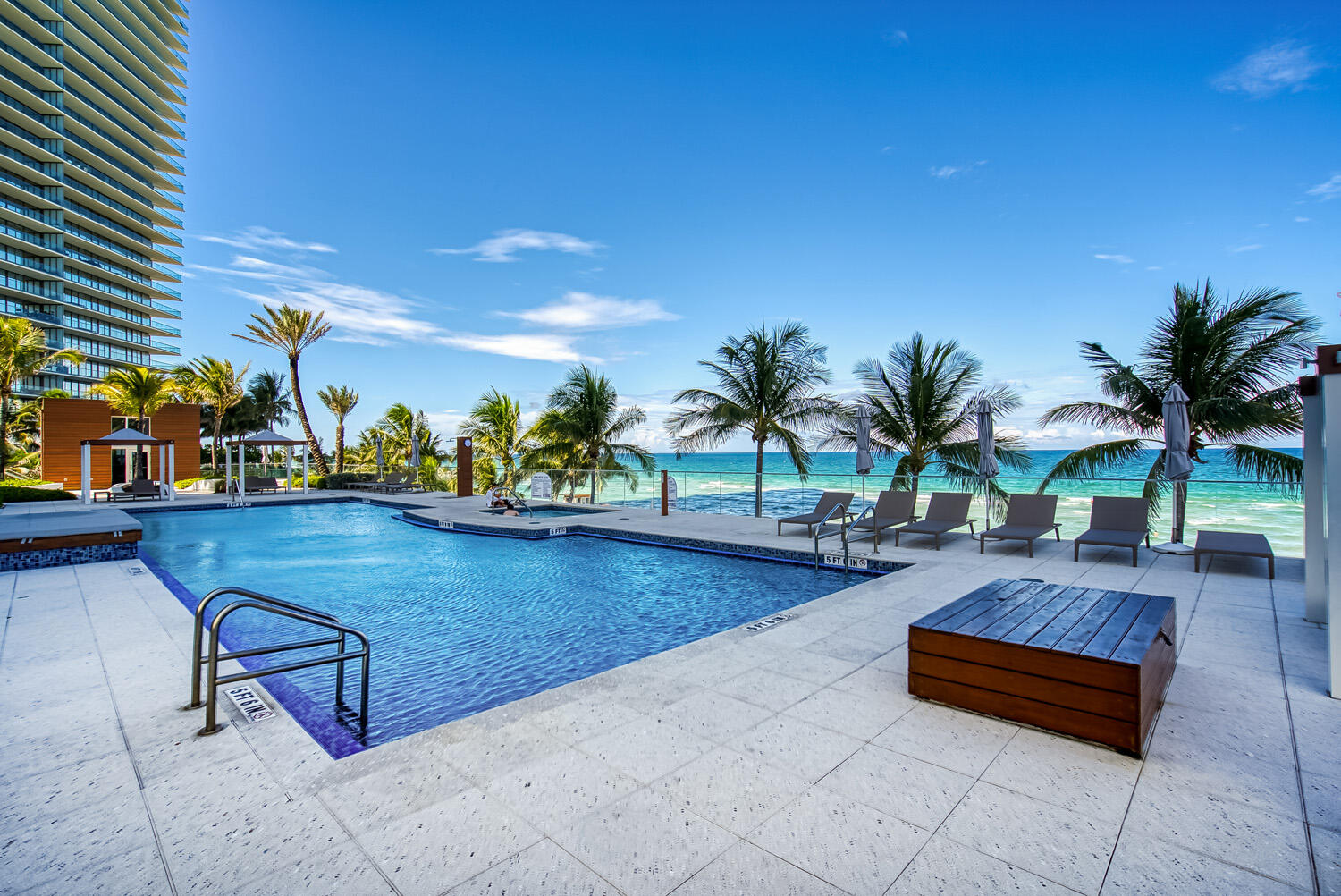 18911 Collins Avenue, Unit 506 ON 5 Sunny Isles Beach, FL 33160 - Photo 64 of 88 a swimming pool with outdoor seating and a potted plant