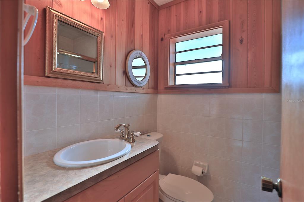 2155 Southeast County Highway 484 Belleview, FL 34420 - Photo 15 of 41 a bathroom with a toilet sink and mirror