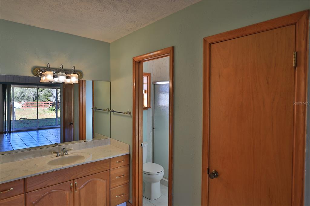 2155 Southeast County Highway 484 Belleview, FL 34420 - Photo 17 of 41 a bathroom with 2 sink and a mirror