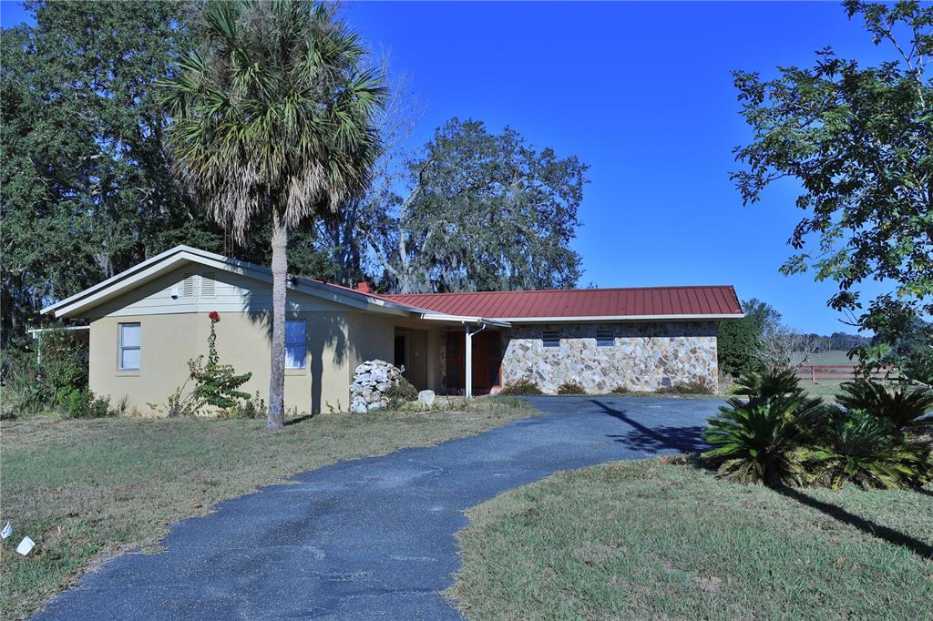 2155 Southeast County Highway 484 Belleview, FL 34420 - Photo 30 of 41 a view of a house with backyard and a tree