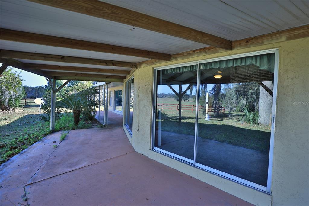 2155 Southeast County Highway 484 Belleview, FL 34420 - Photo 32 of 41 a view of a room with wooden floor and outdoor space
